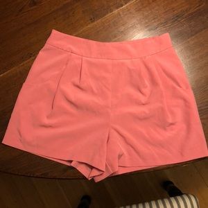 High-waisted pink shorts.